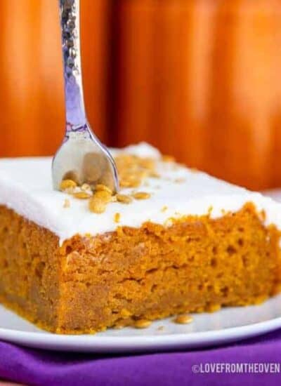 A pumpkin bar on a plate with a fork in it.