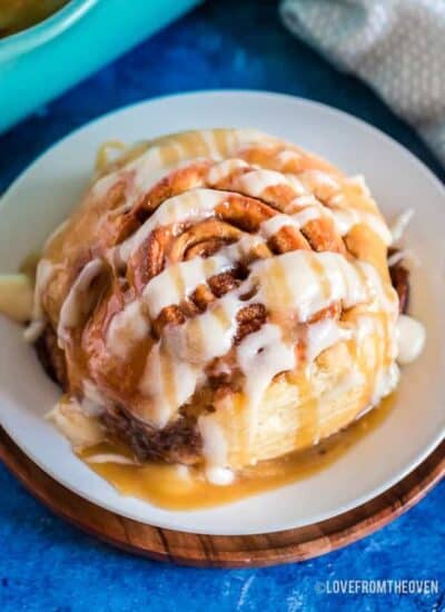 Close up of a homemade cinnamon roll on a white plate