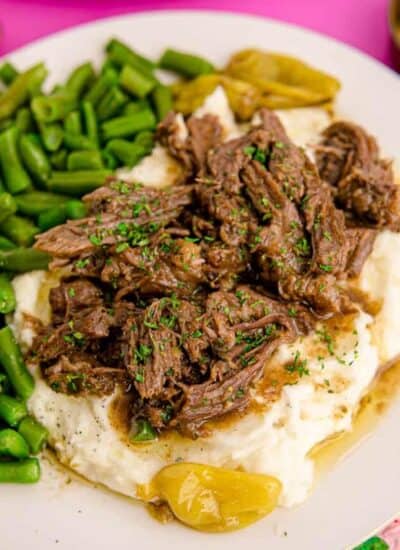 a plate with roast potatoes and green beans