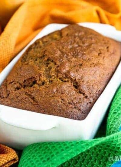 Pumpkin bread in a white bread pan.