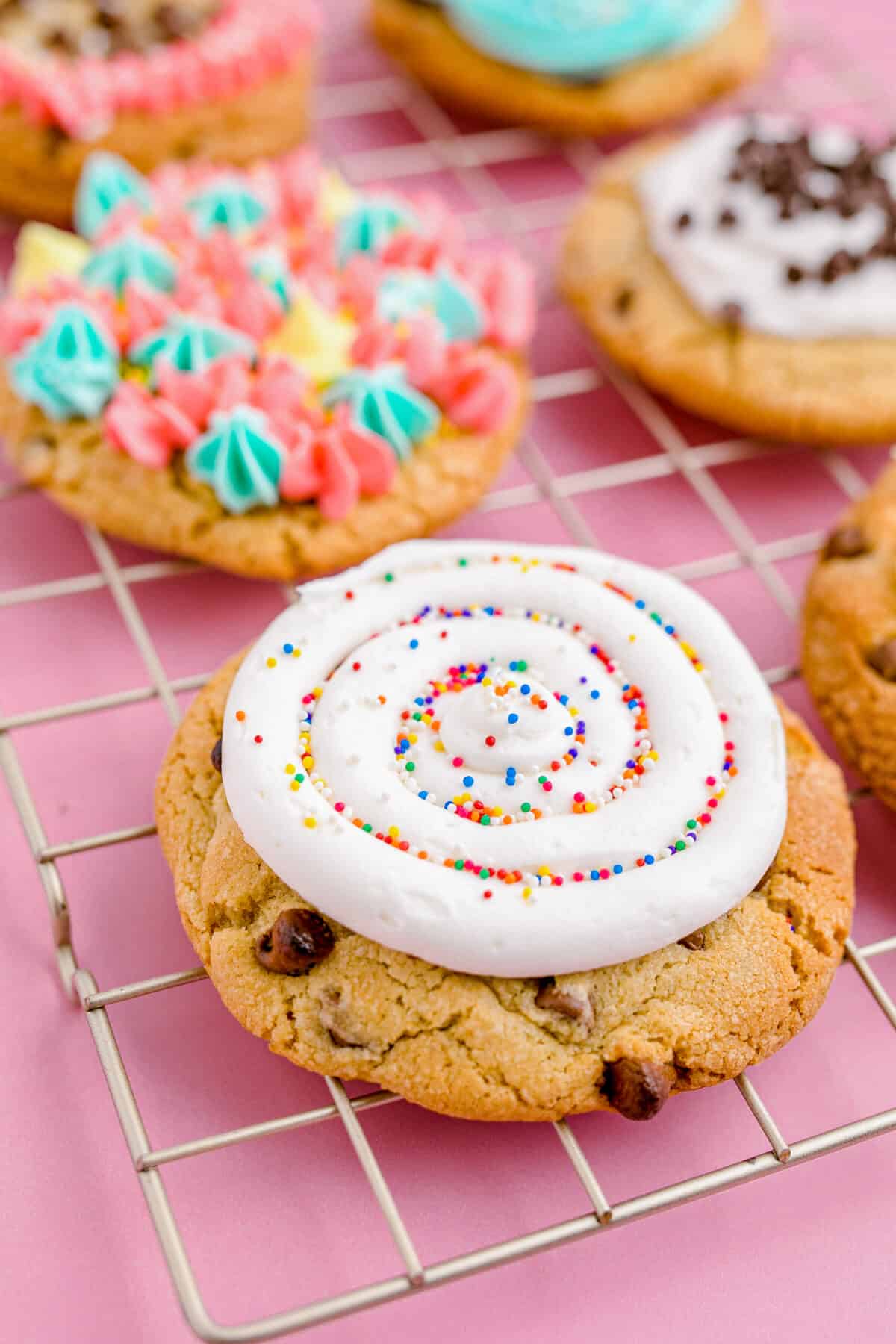 A chocolate chip crumbl cookie with white frosting