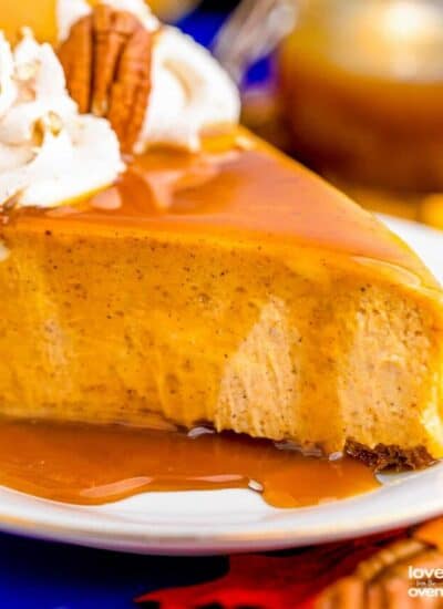 a slice of pumpkin cheesecake with caramel sauce on top