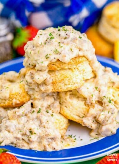 A stack of biscuits and gravy on a blue and white plate.