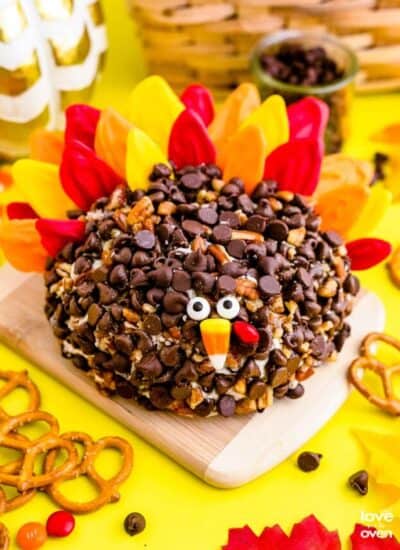 a turkey cheeseball on a wooden cutting board