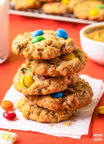 A stack of monster cookies on a napkin