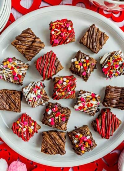 decorated valentine brownie bites on a white plate