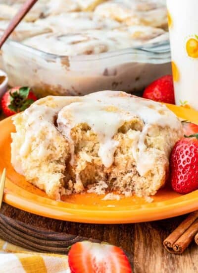 An overnight cinnamon roll on an orange plate