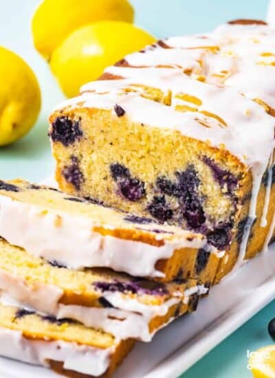 A loaf of lemon blueberry bread with lemon glaze