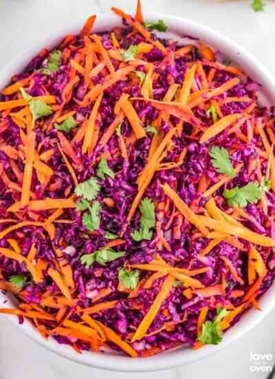 a large serving bowl of red cabbage slaw