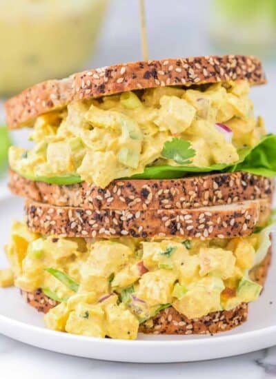 curried chicken salad sandwiches stacked on top of each other