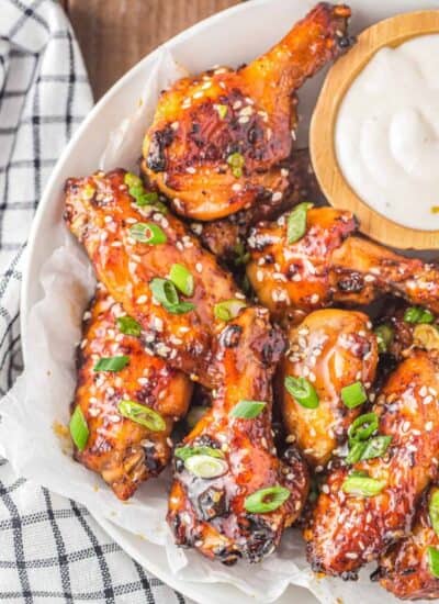 a plate of honey garlic chicken wings and ranch