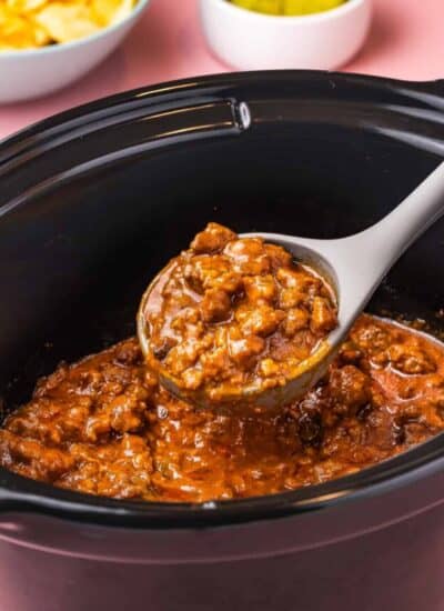 a ladle holding some crokpot sloppy joe filling