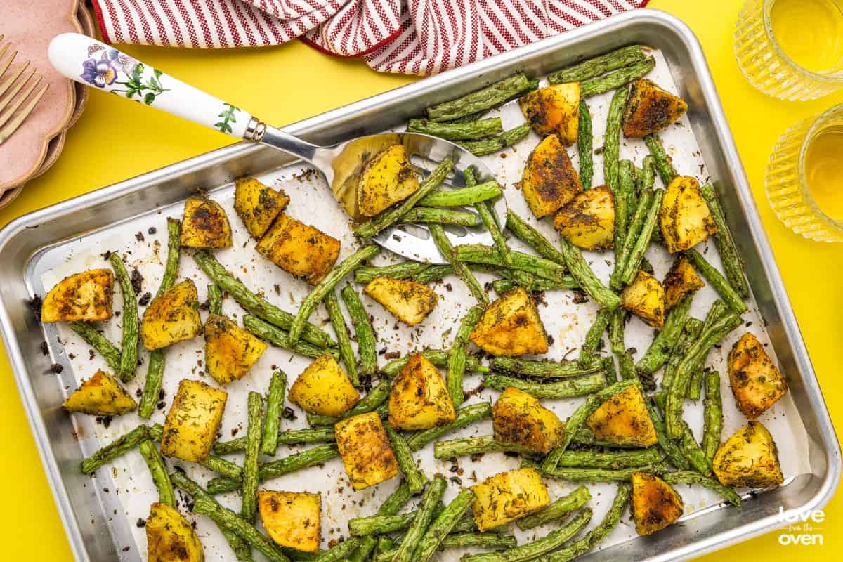 green beans and potatoes on a baking sheet