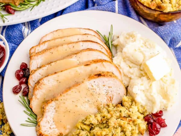 Turkey, mashed potatoes and stuffing on a plate.